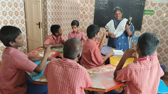 A teacher with children in the classroom